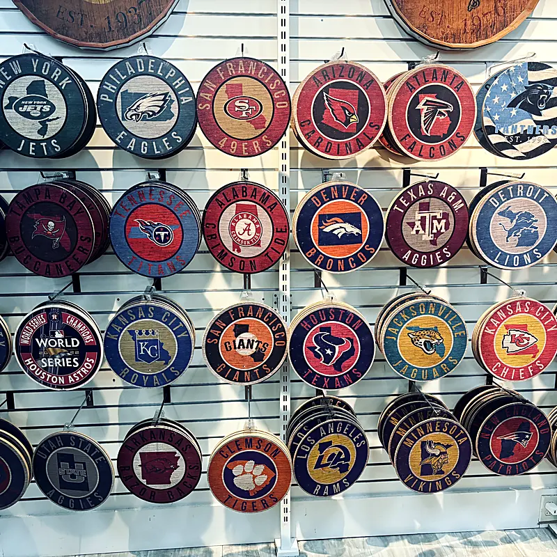 Wall of round wooden NFL and MLB team signs