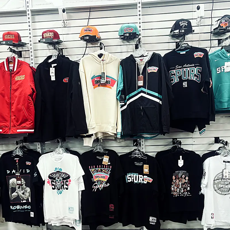 Spurs hoodies and tees on the apparel wall at Sports Zone
